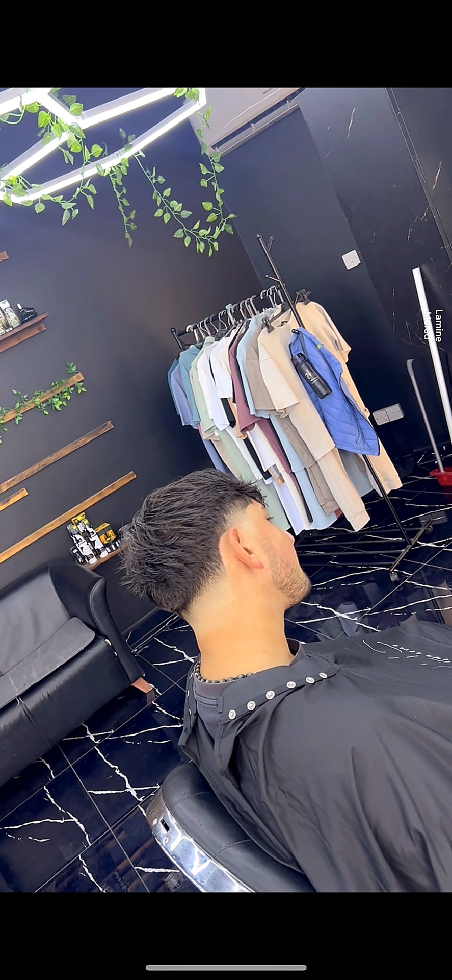 Textured haircut with a clean fade at Kritikos Barbershop